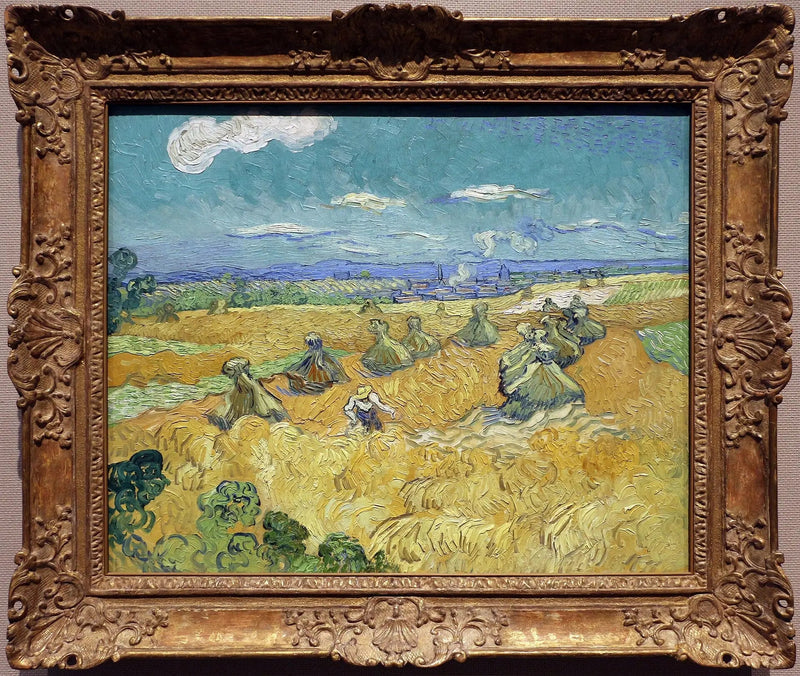Campo di grano con covoni e mietitrice - Vincent van Gogh