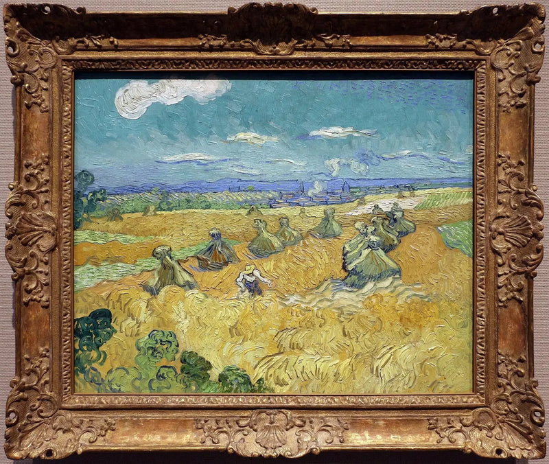 Campo di grano con covoni e mietitrice - Vincent van Gogh